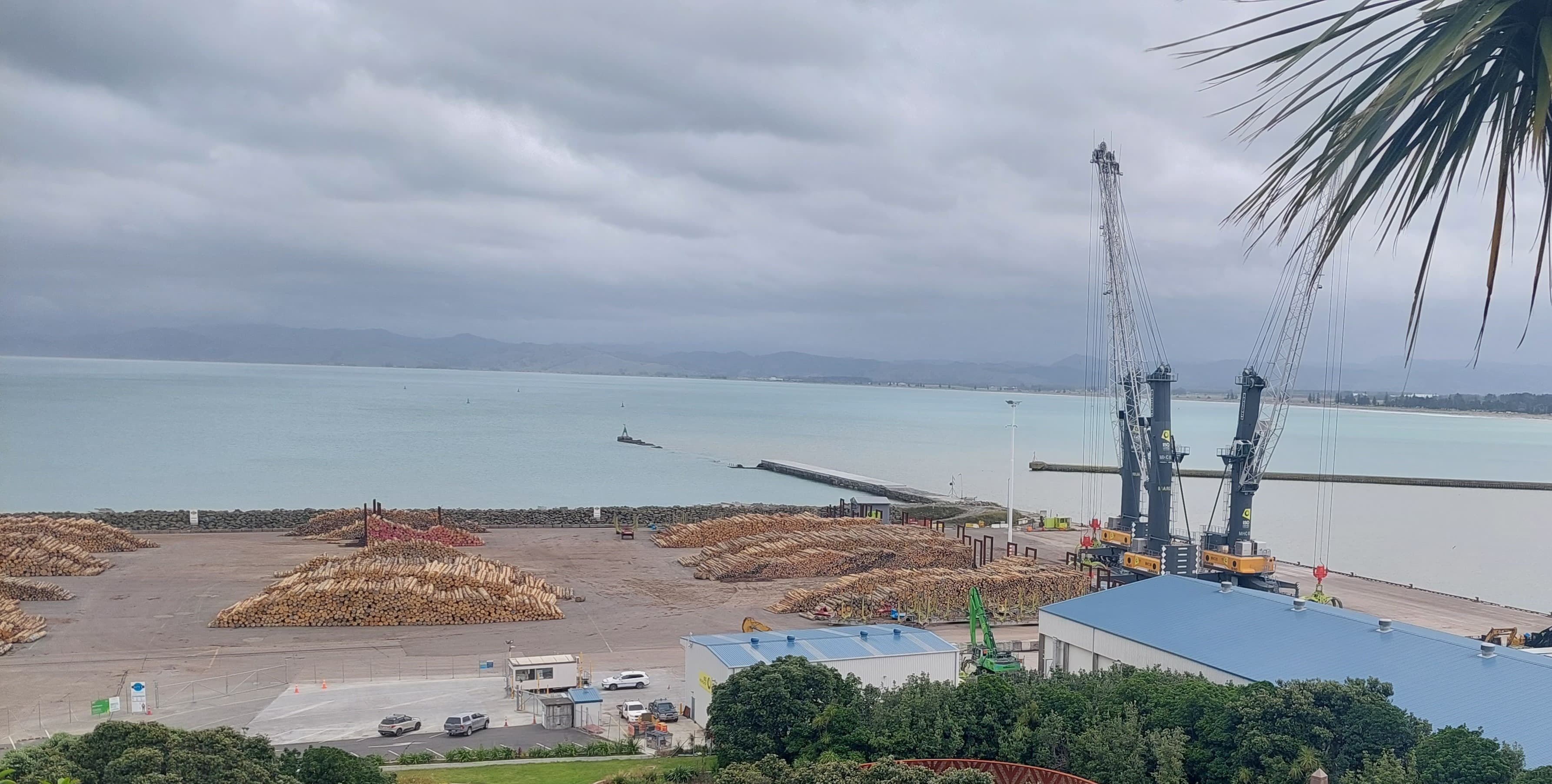 Coastal port with cranes, logistics, and breakwater