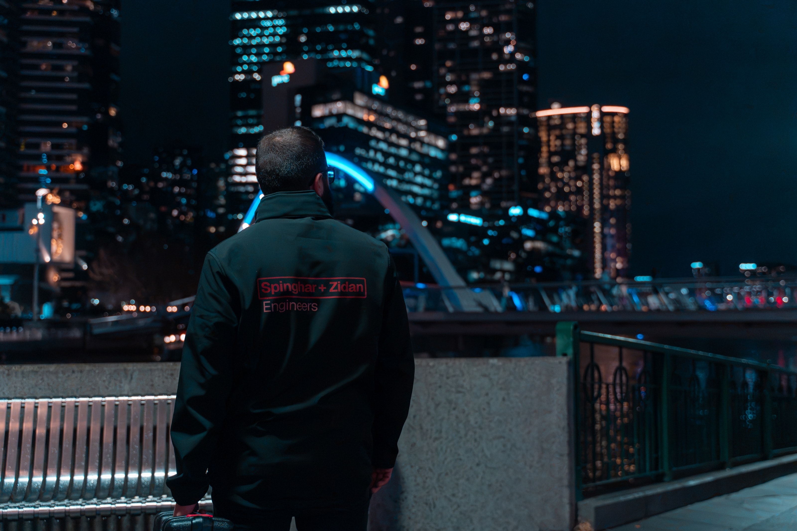 SZE engineer overlooking city skyline at night