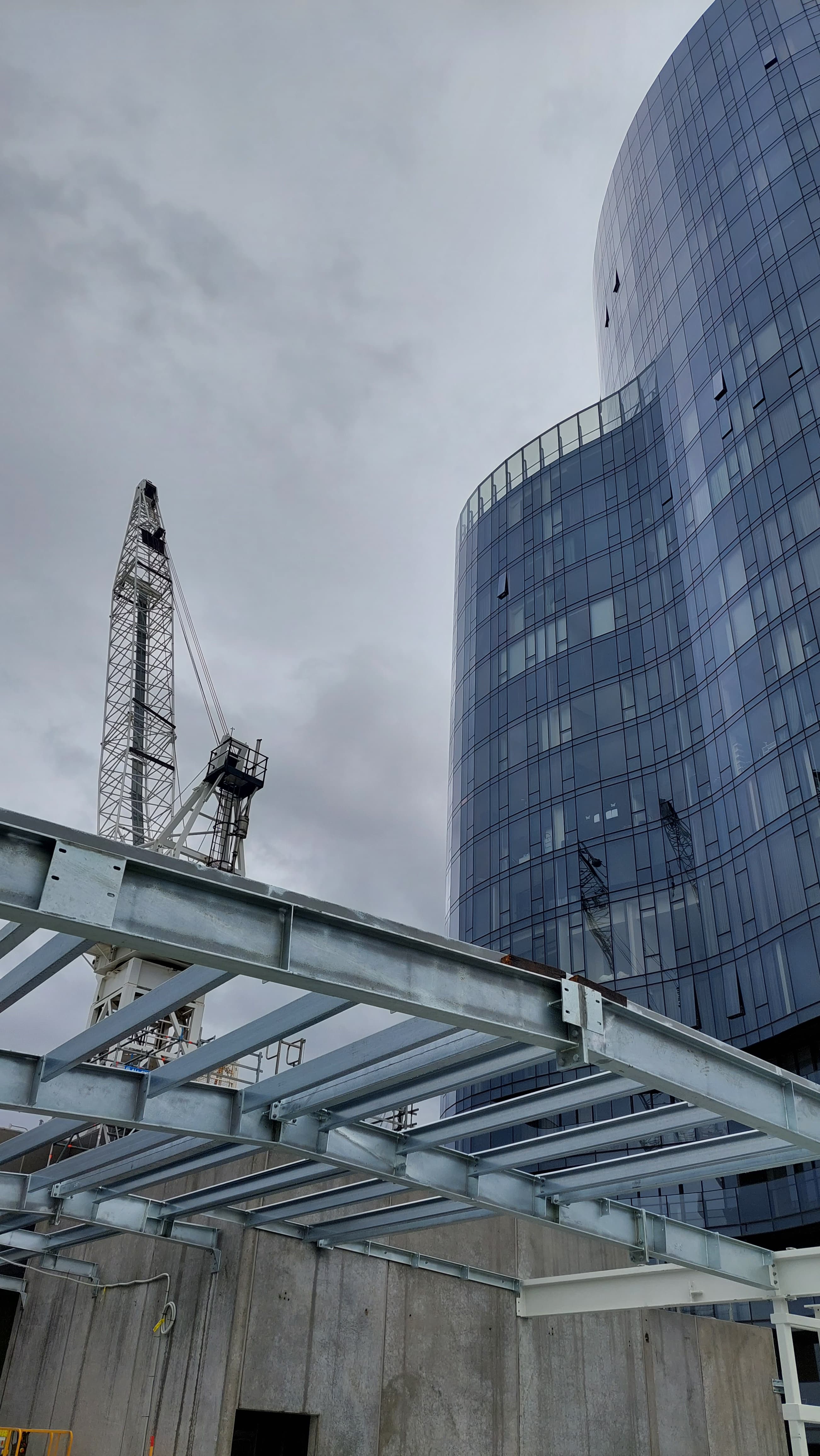 Structural steel frame and tower crane at a high-rise construction site
